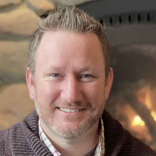 Headshot of Alex Patterson Vacation with Fire Background